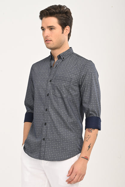 Man wearing a patterned shirt with rolled-up sleeves