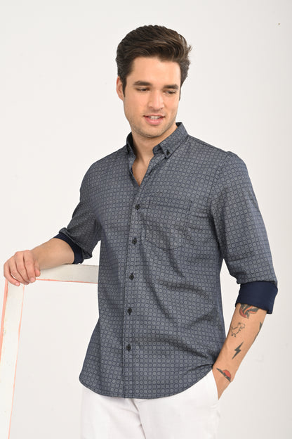 Man wearing a patterned shirt with rolled-up sleeves