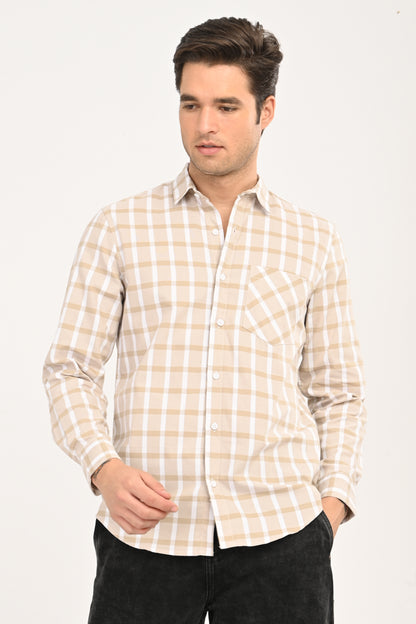 Model wearing a sand beige and white windowpane plaid casual shirt with black jeans.